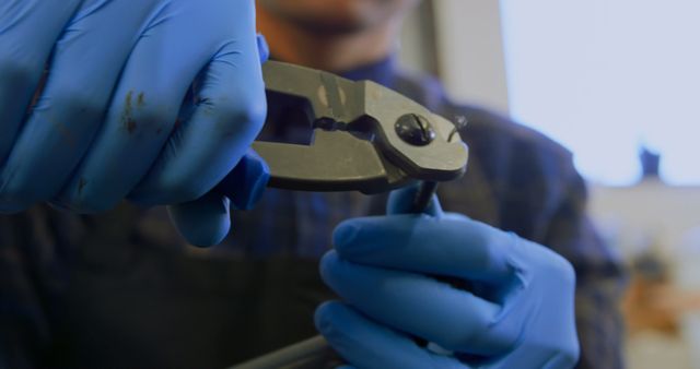 Engineer Wearing Blue Gloves Cutting Wire with Pliers in Workshop - Download Free Stock Images Pikwizard.com