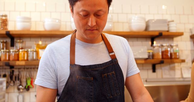 Asian Chef Cooking in Modern Kitchen Wearing Denim Apron - Download Free Stock Images Pikwizard.com