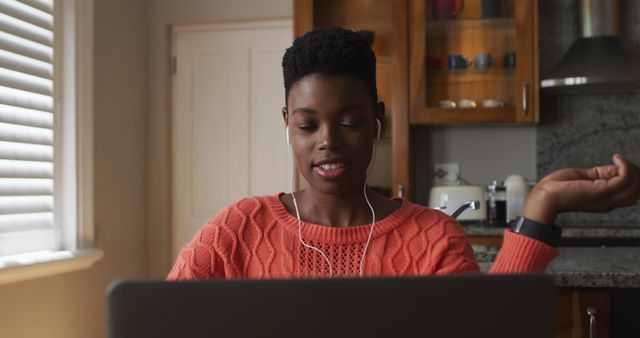 Smiling African American Woman Wearing Earbuds Working on Laptop at Home - Download Free Stock Images Pikwizard.com