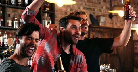 Friends Celebrating Exciting Sports Event at Bar - Download Free Stock Images Pikwizard.com