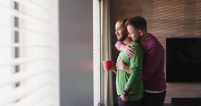 Loving Same-Sex Couple Embracing Near Sunlit Window at Home - Download Free Stock Images Pikwizard.com