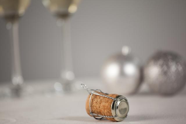 Close-up of Champagne Cork with Christmas Ornaments and Glasses - Download Free Stock Photos Pikwizard.com