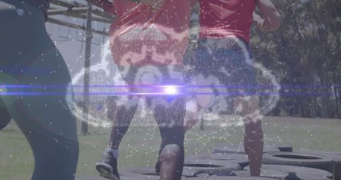 Team navigating tire obstacle with digital cloud overlay