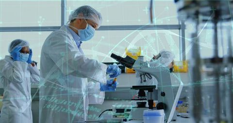 Researcher examining vial at microscope with DNA data overlay in sterile biotech laboratory