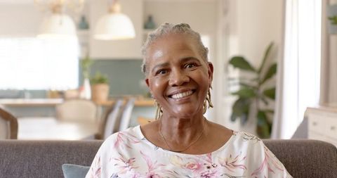 Smiling Senior African American Woman Relaxing in Stylish Living Room