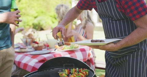 Family Enjoying Summer Barbecue Gathering Outdoors