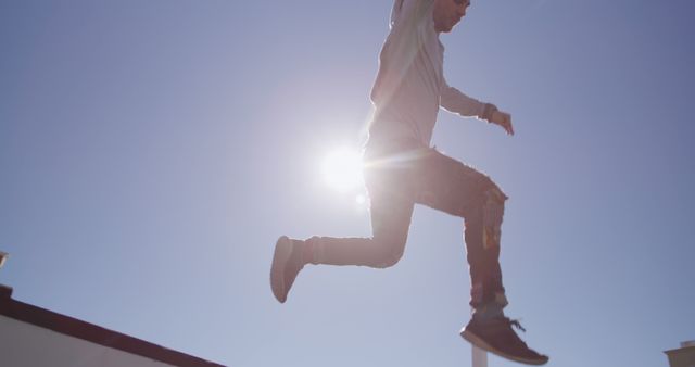 Young Man Jumping with Blue Sky Background and Sunshine - Download Free Stock Images Pikwizard.com