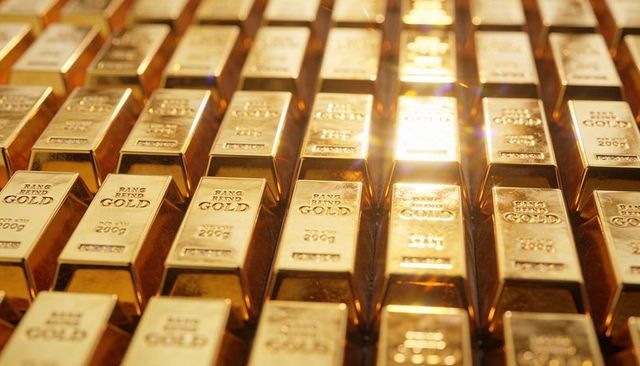 Gleaming rows of gold bars reflecting light in secure vault