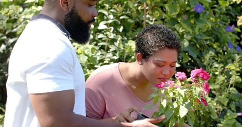 Couple Engaging in Spring Gardening with Vibrant Flowers Outdoors