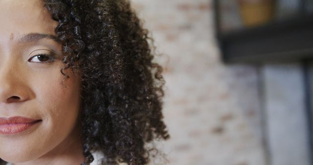 Confident Woman With Curly Hair Smiling Indoors - Download Free Stock Images Pikwizard.com