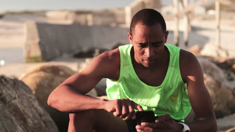 Athlete Relaxing and Using Smartphone Post-Workout in Nature