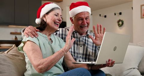 Senior Couple Video Chatting in Santa Hats During Festive Season