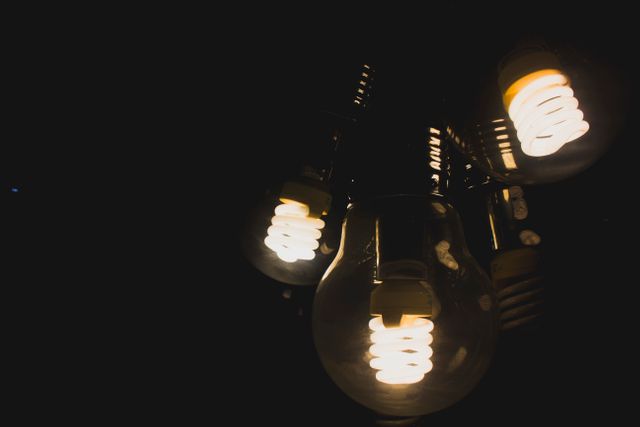 Glowing Energy-Saving Light Bulbs in Darkness - Download Free Stock Photos Pikwizard.com