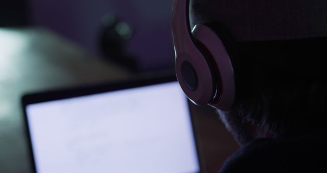 Man Wearing Headphones Using Laptop at Night - Download Free Stock Images Pikwizard.com