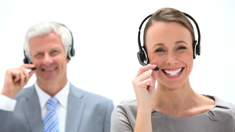 Smiling Customer Service Team Using Headsets