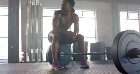 Strong Woman Resting with Barbell in Gym After Workout - Download Free Stock Images Pikwizard.com