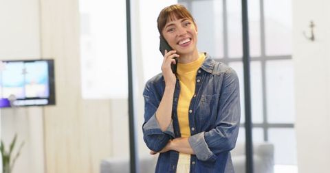 Professional Woman Engaged in Phone Conversation at Modern Office