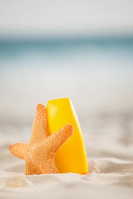 Bottle of sunscreen lotion and starfish kept on sand - Download Free Stock Photos Pikwizard.com