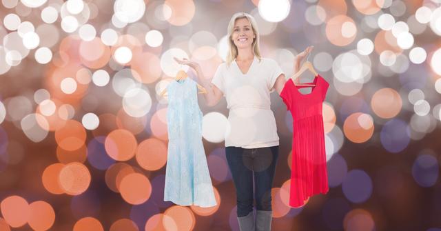 A woman smiles while holding red and blue dresses against a bokeh background. This image is perfect for use in advertising fashion choices, clothing stores, online shopping platforms, and lifestyle blogs. Ideal for promoting new collections or sales in retail sectors.