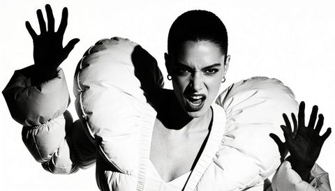 High-contrast monochrome fashion portrait featuring fierce pose, oversize puffer sleeves