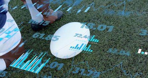 Rugby player kneeling steadying ball on turf wearing cleats displaying AR analytics