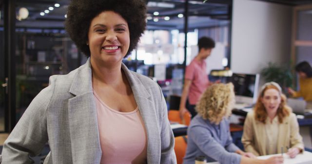 Portrait of happy biracial businesswoman looking at camera at office. Work at a modern office.