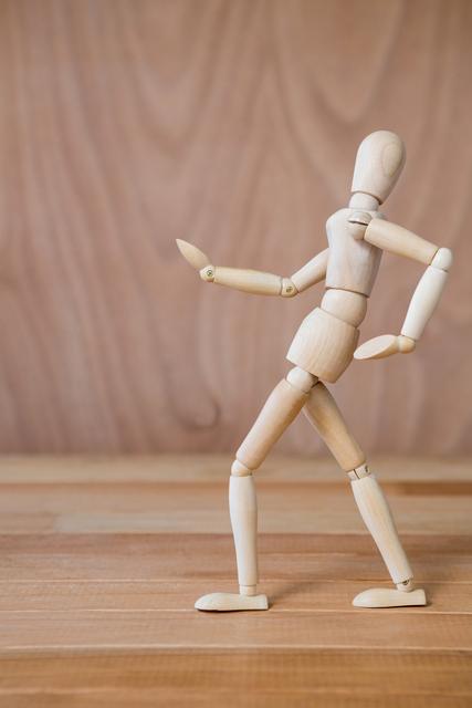 Conceptual image of figurine walking on a wooden floor