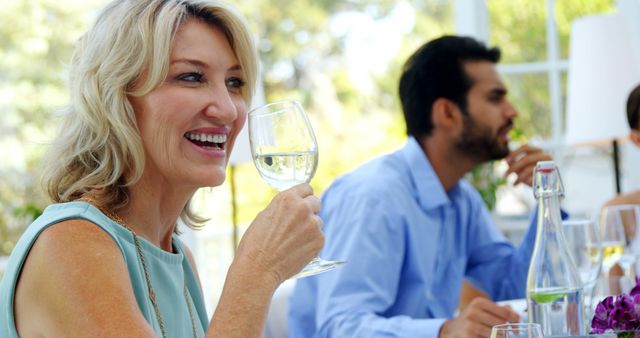 Mature Woman Smiling with Wine Glass During Outdoor Gathering - Download Free Stock Images Pikwizard.com