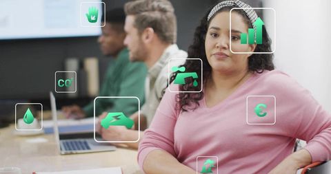 Woman sitting in corporate meeting evaluating sustainability metrics with green icons overlay