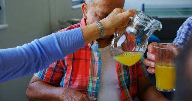 Elderly Man Receiving Glass of Fresh Orange Juice at Breakfast - Download Free Stock Images Pikwizard.com