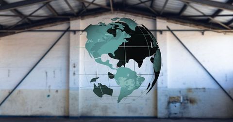 Spinning Green Globe in Industrial Warehouse - Download Free Stock Images Pikwizard.com