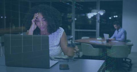 Working Late in Coworking Office Woman Rubbing Forehead at Laptop with Digital Data Overlay