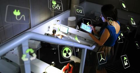 Businesswoman Interacting with Virtual Icons on Holographic Interface