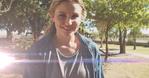 Smiling Young Mother Enjoying Sunny Park Outdoors