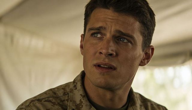 Looking concerned soldier wearing desert camo inside canvas tent closeup portrait