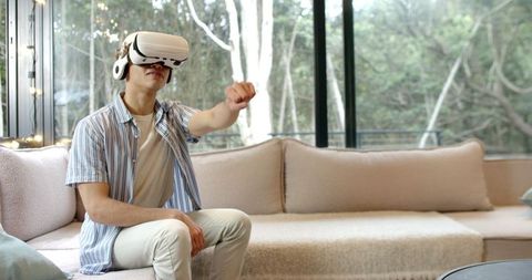 Young Man Enjoying Virtual Reality Experience at Home