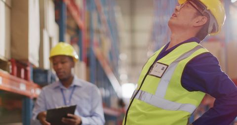 Warehouse Workers Experiencing Back Pain While Supervising - Download Free Stock Images Pikwizard.com