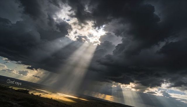 Sunbeams Piercing Storm Clouds Over Prairie, Crepuscular Rays Breaking Through
