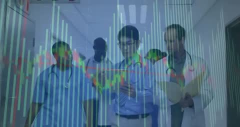 Medical Team Analyzing Digital Data While Walking Hospital Corridor