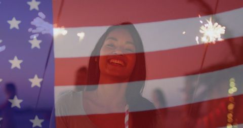 Young Woman Celebrating with American Flag and Sparkler