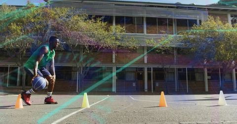 Athlete Dribbling Basketball on School Court with Training Cones