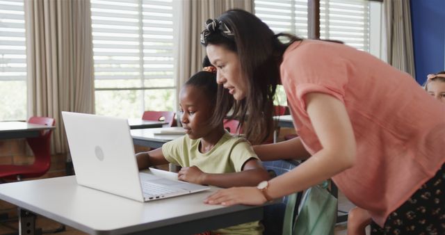 Teacher Assisting Student in Classroom with Laptop - Download Free Stock Images Pikwizard.com