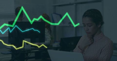 Businesswoman Analyzing Data with Digital Graph Overlays in Office