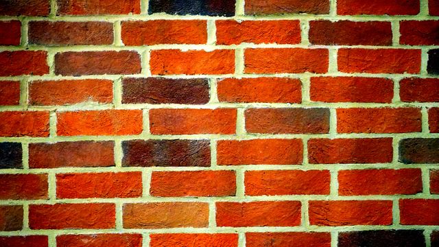 Brick wall displays varied shade patterns, offering a solid and rustic texture. Ideal for use as a background for construction themes, architectural projects, or outdoor landscaping materials. Useful for graphic design, website backgrounds, or presentations highlighting building materials.