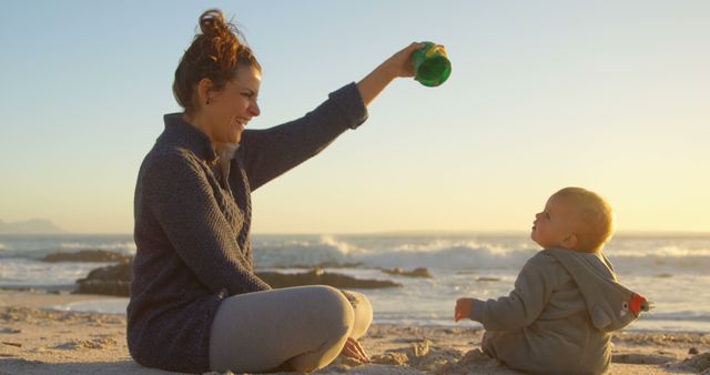 Mother Playing with Baby at the Beach During Sunset - Download Free Stock Images Pikwizard.com