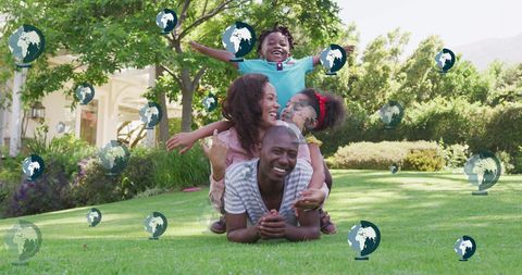 Happy Family Playing in Garden with Globe Icons Overlay