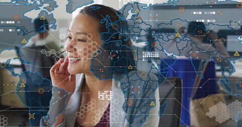 Smiling Asian Businesswoman Surrounded by Digital Global Map