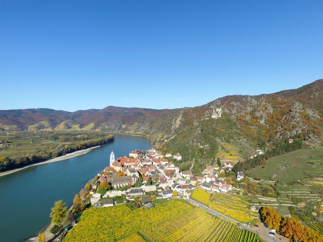Aerial View of Picturesque Village Along River in Autumn - Download Free Stock Photos Pikwizard.com