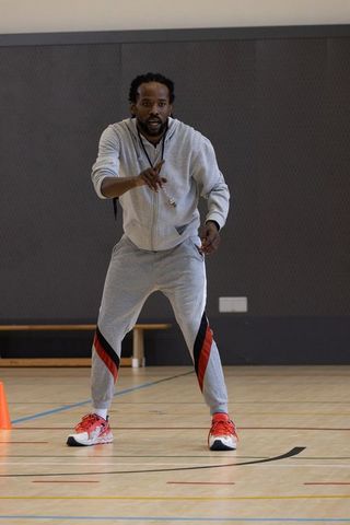 Dedicated coach training with intensity and expertise on gym floor