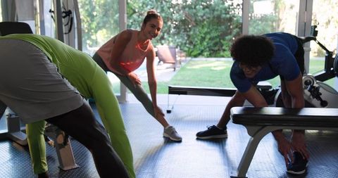 Group Stretching and Preparing for Workout in Gym